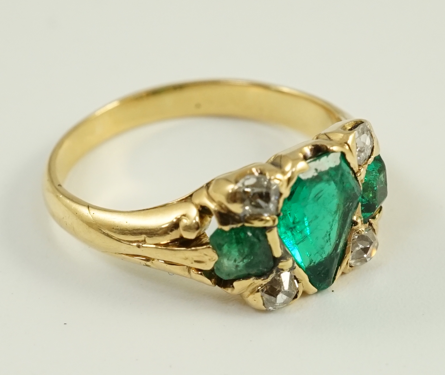 A gold, emerald and diamond cluster ring